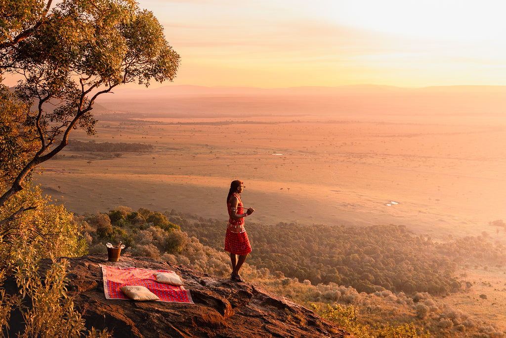 Maasai warrior overlooking the Serengeti plains at sunset